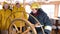 Woman captain of ship turning steering wheel in navigation bridge at sailing ship. Woman sailor steering helm of sailing