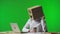 Woman with cardboard box on her head on green studio background. Employee with sad emoji is drinking coffee, turns the