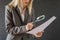 Woman carefully reading business contract with magnifying glass