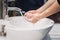 Woman carefully washing hands with soap and sanitiser at home during worldwide coronavirus pandemic