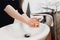 Woman carefully washing hands with soap and sanitiser at home during worldwide coronavirus pandemic