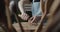 Woman carpenter carves piece of wood making a spoon close-up