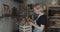 Woman carpenter chooses wooden blank for carving a spoon