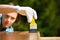 Woman carpenter inspecting freshly painted wood