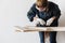 Woman carpenter using hammer pushing nail on a wood