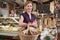 Woman Carrying Basket Of Groceries In Delicatessen