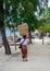 A woman carrying baskets on head in Bali, Indonesia