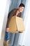 Woman carrying cardboard box