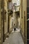 Woman carrying groceries in the old downtown historic district of Ortigia, Sicily