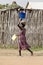 Woman carrying items on head in Africa