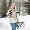 Woman carrying ski gear.