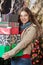 Woman Carrying Stacked Gift Boxes In Christmas