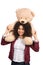 Woman is carrying a teddy bear on her shoulders