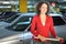 Woman with cart standing in underground car park