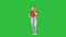 Woman in casual walking and talking on the phone on a green screen, chroma key.