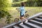 A woman in casual wear is taking a folding bike down the stairs.