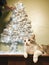 Woman and a cat decorating the Christmas tree.