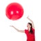 Woman catching big red balloon above her head