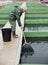 Woman catching fish with landing net on sturgeon farm