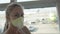 Woman caucasian at airport with wearing protective medical mask on head against the background of the plane. Coronavirus