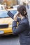 Woman on Cell Phone Hailing a Yellow Taxi Cab