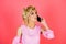 Woman with cell phone. Young woman over isolated pink background with phone. Young blonde woman with smart phone.