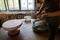 Woman ceramics artist molding raw clay for sculpturing pottery on potter wheel. Female art teacher