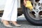 Woman changing car tyre