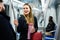 Woman chatting with fellow traveler in subway car