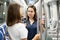 Woman chatting with fellow traveler in subway car