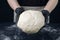 Woman in checkered apron and black gloves hold a piece of yeast dough. Process of making bakery. Adjarian Khachapuri Recipe â€“