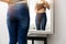 Woman checking her body in front of mirror