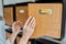 Woman checking mailboxes inside an apartment building