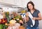 Woman checking purchases in kitchen