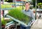 Woman checking seedlings in garden store