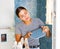 Woman checks quality of ceramic tiles in a bathroom being renovated