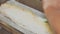 Woman Chef Baking Apple Strudel. Female Hands Applying Egg Wash onto Dough with Basting Brush