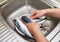 Woman chef cleans fish mackerel in water