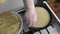 Woman chef cooks pancakes in home kitchen
