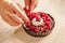 Woman chef preparing chocolate cake with whipped cream and raspberry