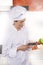 Woman chef reading smartphone