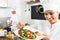 Woman chef serving fresh salad