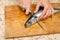 A woman chef slices a fish mackrel on a wooden Board