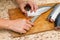 A woman chef slices a fish mackrel on a wooden Board