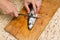 A woman chef slices a fish mackrel on a wooden Board