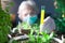 woman chemist experimenting with chemicals and plants holding a test tube