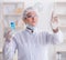 Woman chemist pressing virtual button in lab