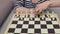 Woman in chess make a move ahead with pawn