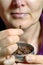 Woman chew dried clove spice