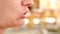 A woman chewing food from a close-up fork. profile. Slow motion